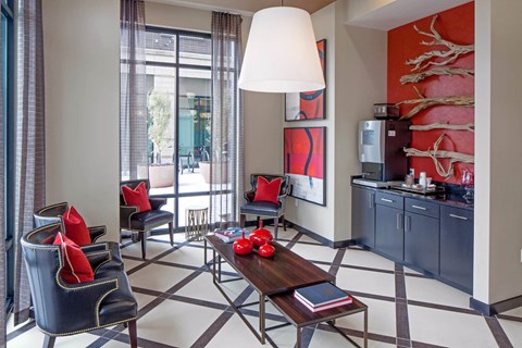 a living room with a table and chairs    and a kitchen